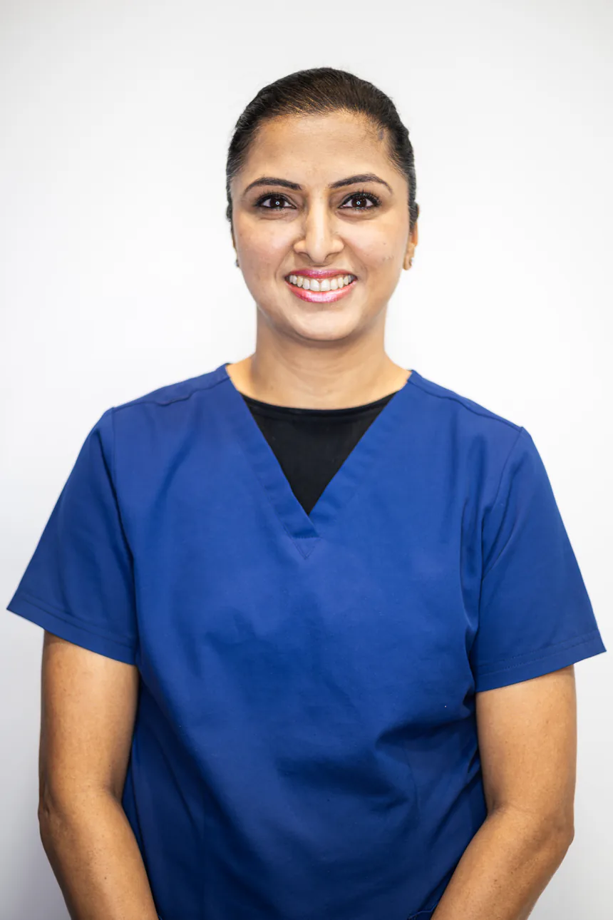 Portrait of Dr Neha Singh in blue scrubs